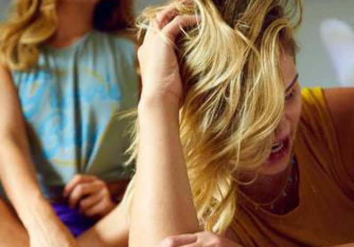 Woman shows signs of emotional abuse with family and friends