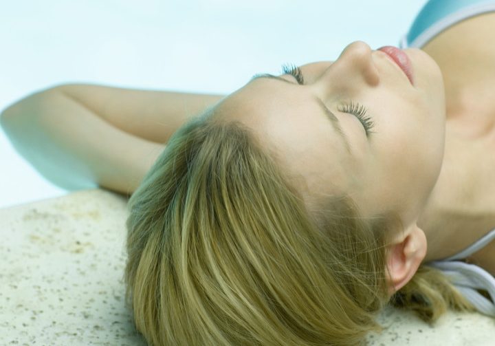 Young Woman Lying by Edge of Pool, Eyes Closed